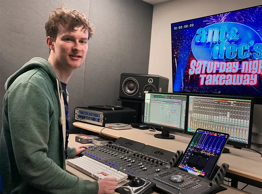 Sound engineer Mark Hennessy at a mixing desk with Ant & Dec's Saturday Night Takeaway on screen.