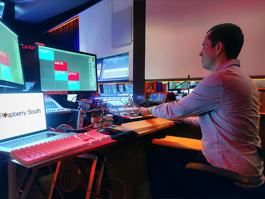 Sound engineer Matt Ingram operating a mixing desk in a control room.